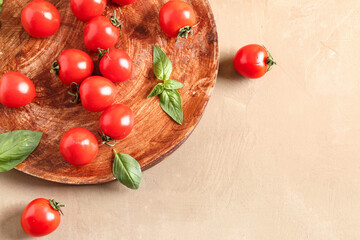 Wooden table with fresh cherry tomatoes and basil on brown table