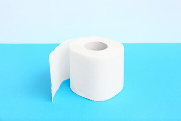 Roll of toilet paper on blue background
