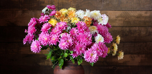 Vibrant bouquet of chrysanthemums adds a touch of color to a rustic setting