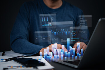Business analyst using laptop with digital data charts, financial performance tracking, business intelligence, and market trend analysis for growth planning.