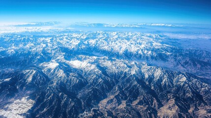 Fototapeta premium Aerial view of snow-capped mountain range.