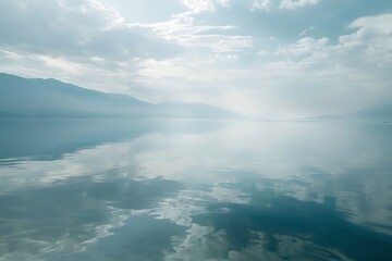 Fototapeta premium Calm lake reflecting the sky, clear water, serene atmosphere, wide angle