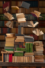 Stacks of many books on a shelf or table. Concept of library, reading, old classic literature. Flying or falling levitating books