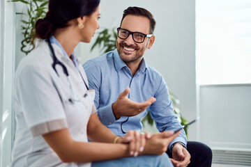 Smiling Doctor and Patient Talking During a Friendly Consultation in a Bright Room