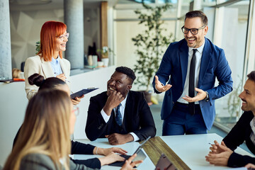 Happy Business Team Engaging in Active Discussion During a Professional Meeting