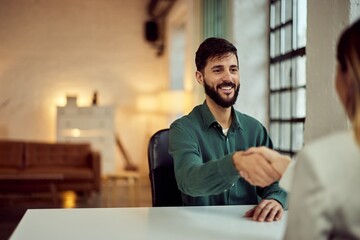 Professional Handshake in Modern Office Setting with Smiling Businessman