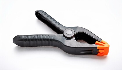 Obraz premium black and orange plastic spring clamp lying on white background