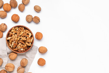 Bowl with walnuts on white background