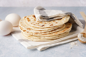 Tasty pita bread, eggs and flour on white background