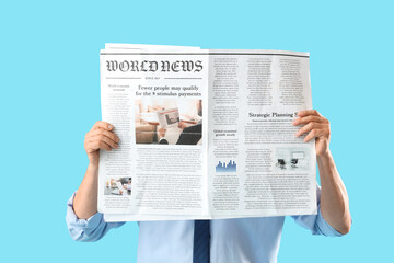 Mature journalist with newspaper on blue background
