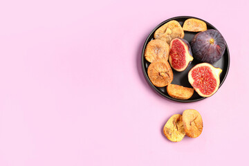 Plate with sweet dried figs and fresh fruits on purple background