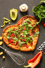 Tasty heart shaped pizza with ingredients on black background