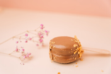 Chocolate french desserts. Cake macaroon on begie background, pastel colors, macaroon decorated with different nuts