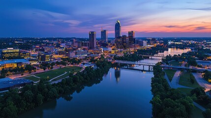 Fototapeta premium Cityscape at sunset with river reflection.