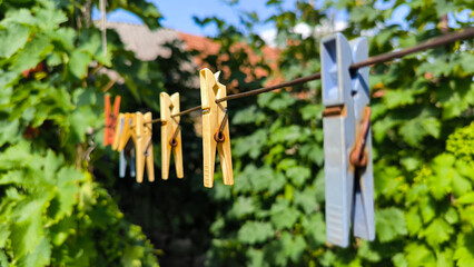 plastic clothes pins hanging on the wire