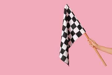 Woman with racing flag on pink background