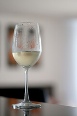Wine glass close-up in real life, beautiful blurred background of the drink in the glass