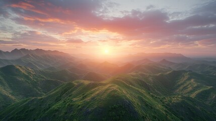 Obraz premium Vibrant sunset over rolling green mountains.