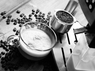 Cup of coffee and coffee machine, making coffee, black and white image