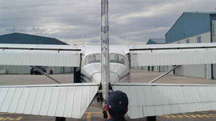 Airplane Preflight - Pilot Checks Elevator during Walk-around REAR
