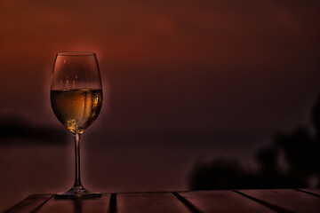 glass of cold white wine on the summer seashore by the water, relaxing by the water, a gentle background of soft color