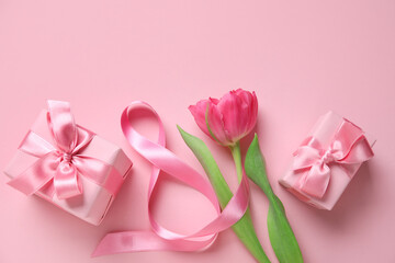 Composition with figure 8 made of ribbon, tulip flower and gift boxes on pink background. International Women's Day celebration