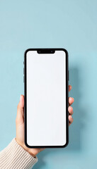 Person holding smartphone with blank screen against blue background  