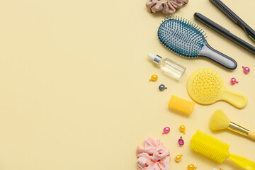 Hair brushes with set of hairdresser tools on yellow background
