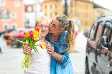 A grateful daughter gives flowers to her loving mother for Mother's Day