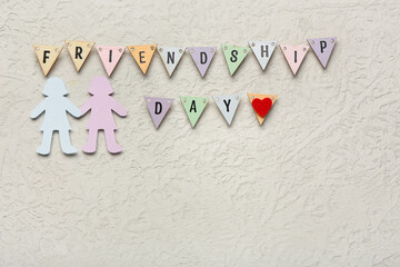 Flags with text FRIENDSHIP DAY and paper female figures on grunge background