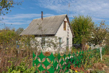 A small brick country house on a summer street.