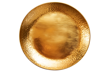 A shiny gold plate with a hammered texture sits against a stark black background in a close up shot