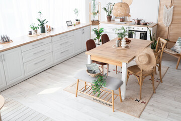 Bench, table and chairs in interior of stylish dining room