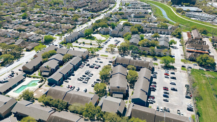 Brays Bayou river area near Corporate Drive, Harris County, fast growing housing market mix of large apartment building complex multistory townhomes, residential single-family houses, aerial view
