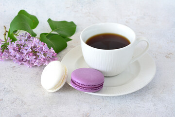Coffee cup with saucer and purple Macarons with Lilacs