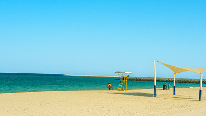 Yellow flag on the beach in summer summer, lifeguards sign to bathe carefully