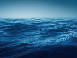 Ocean's rhythmic dance: Captivating deep blue waves under serene sky, embodying peace, vastness, and the beauty of marine environment