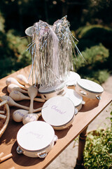 Party favors with tambourines maracas and tinsel bucket on a wooden table