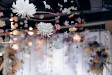 Hanging floral arrangement with white and pink chrysanthemums indoors
