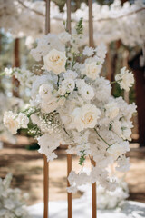 Close-up of an elegant white floral arrangement with peonies and roses