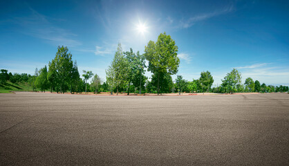 Panoramic empty asphalt road in the park under the blue sky.