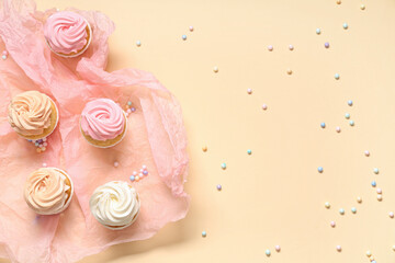 Paper with sweet Birthday cupcakes and sprinkles on beige background