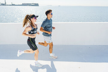 Bright Morning Jog Along the Waterfront, While the Sun Sparkles on the Calm Waters, Energizing the...