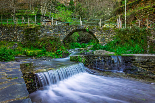 Mountain waterfall in the iconic ancient portuguese stone village of Piodao