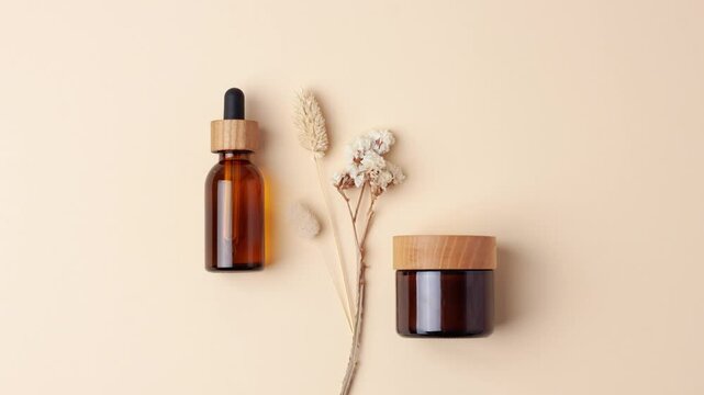 Minimal composition with cosmetic skin care products and flowers on pastel beige background. Flat lay, copy space