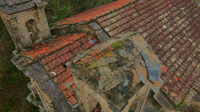 Dynamic FPV drone shot of church Chiesa Pigna San Michele Arcangelo, abandoned ruins, red-tiled roof, rural landscape, for cinematic history projects, Italy