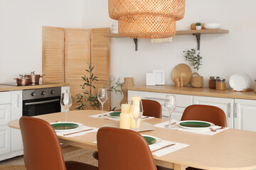 Modern kitchen with romantic candles on served table
