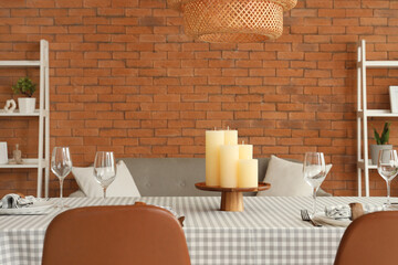 Served dining table with candles in living room