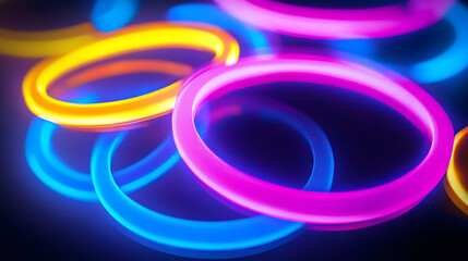 Abstract neon circles of blue, pink, and yellow glow on a dark background.