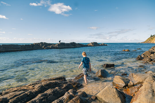 Kids enjoying The Tanks natural tourist attraction at Forster on bright summer day